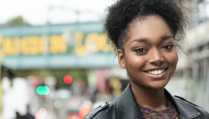 Portrait of young black woman looking in the camera, smilling