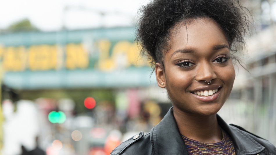 Portrait of young black woman looking in the camera, smilling