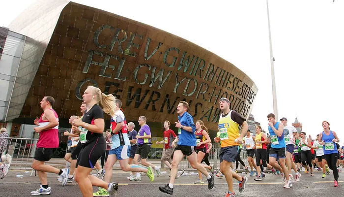 Runners in Cardiff half marathon outside Wales Millenium Centre
