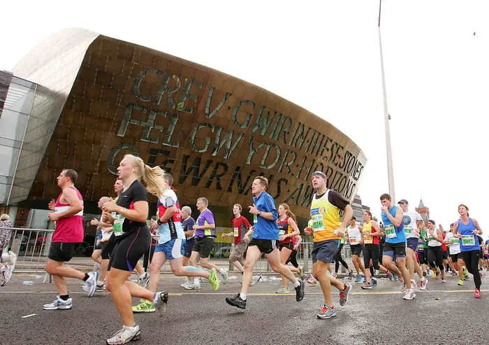 Runners in Cardiff half marathon outside Wales Millenium Centre.jpg
