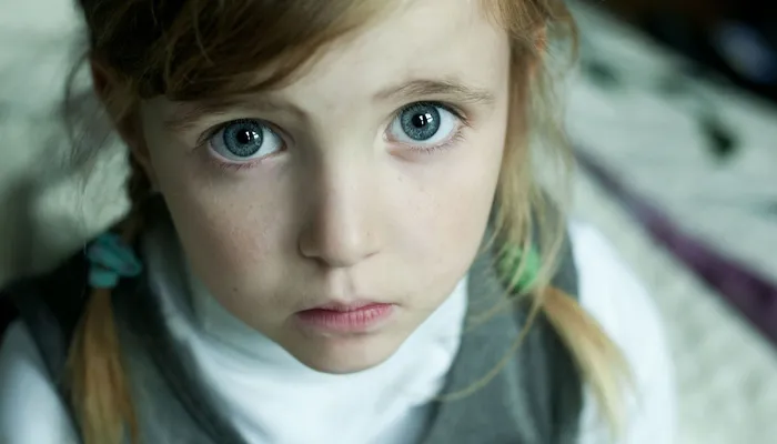 Sad young girl looking up