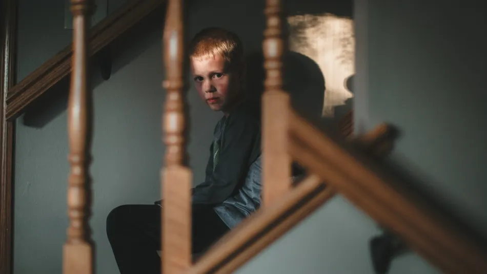 Scared boy on staircase