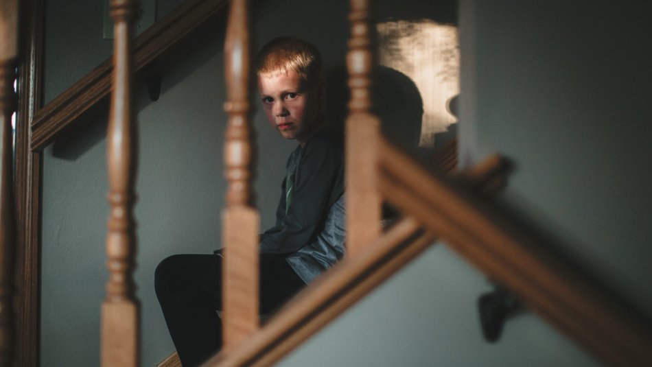 Scared boy on staircase