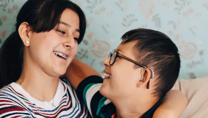 Siblings embracing