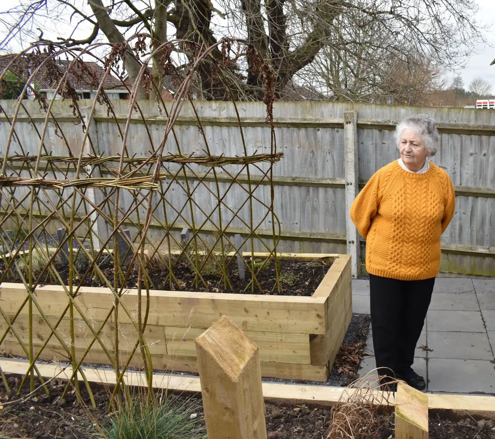 Sister Eluned Williams walking through a garden