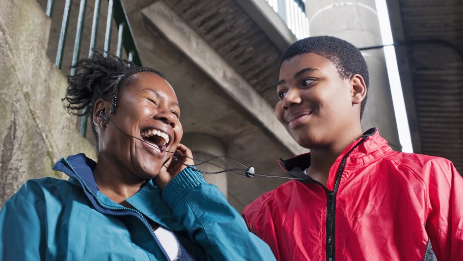 Teenage boy with mother on headphones