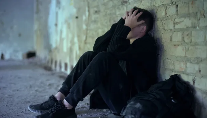 Teenage boy hiding in abandoned building