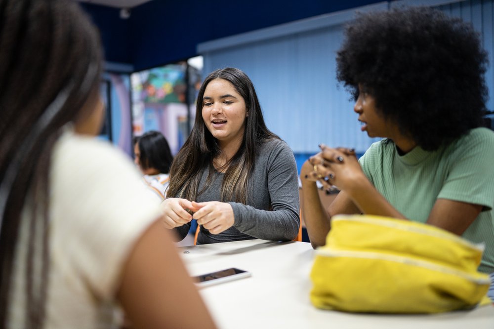 Teenagers in a classroom having a disucssion