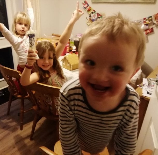 Thomas with his two older sisters at Christmas