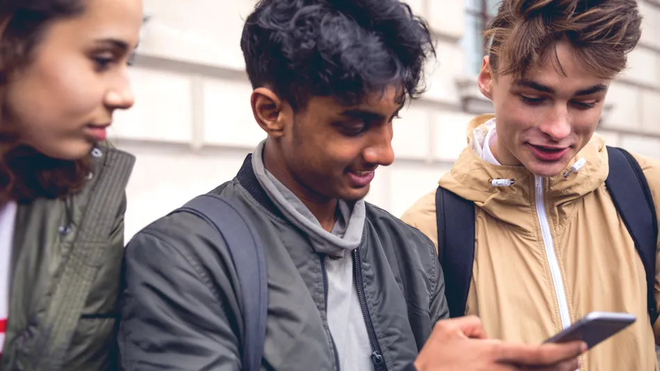 Three teenager looking at phone