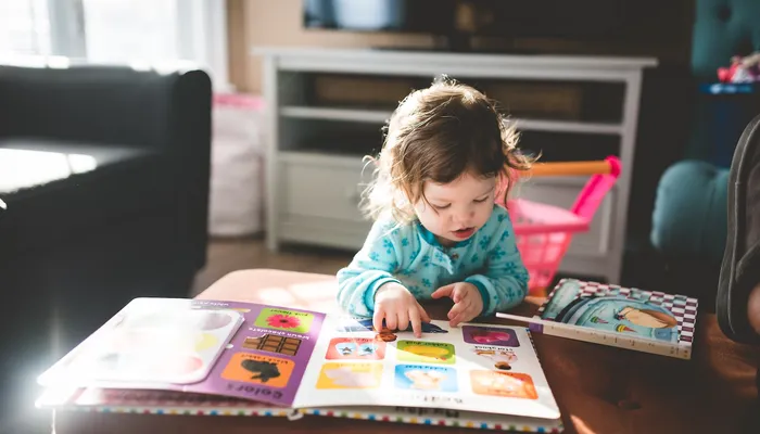 Toddler reading a picture book