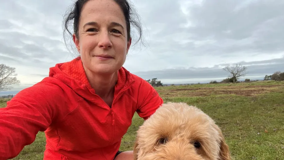Vicky taking a selfie outdoors with her dog
