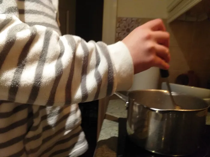 View of Matthew's arm cooking dinner