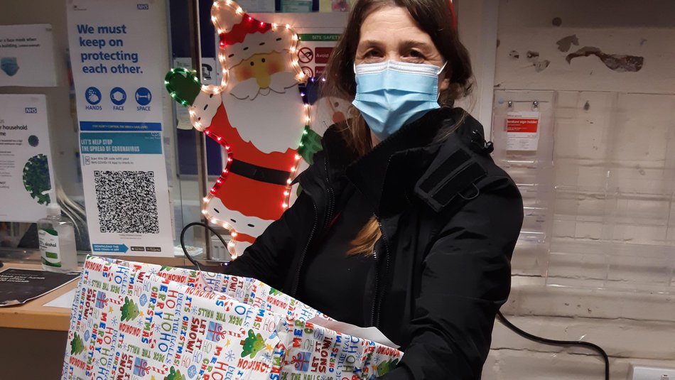 Volunteer holding a christmas hamper.jpg