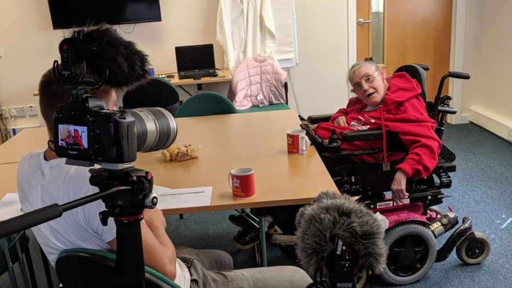 Volunteer interviewing Denise Withers.png