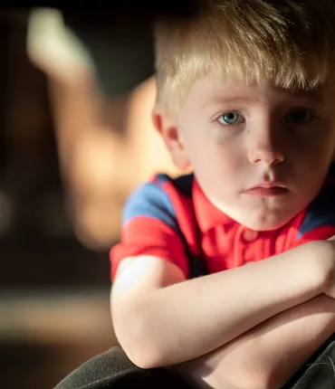 Young boy crossing arms