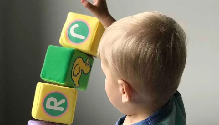 Young boy playing with letter blocks