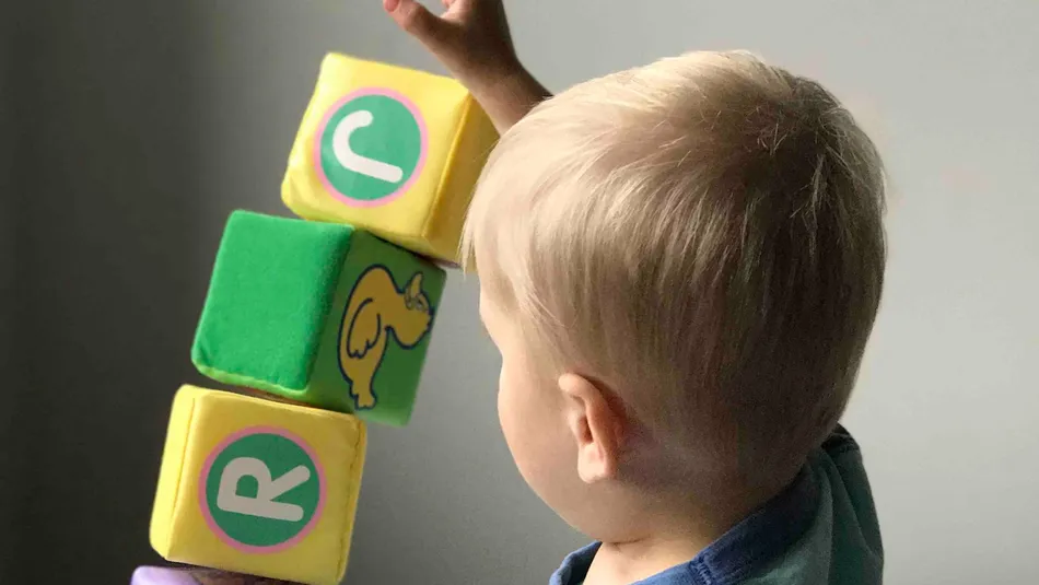 Young boy playing with letter blocks