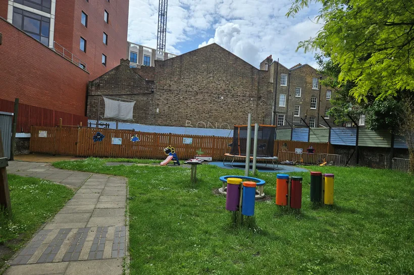 Playground with instruments, a small slide and a trampoline