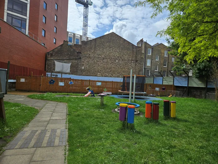 Playground with instruments, a small slide and a trampoline