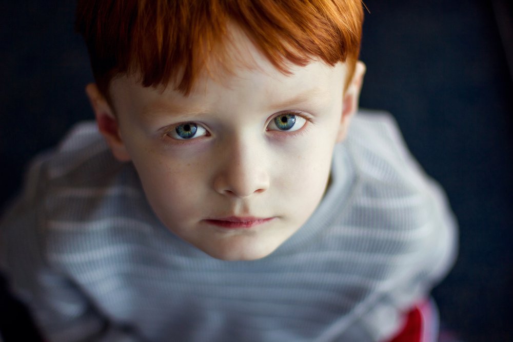 boy staring up at camera