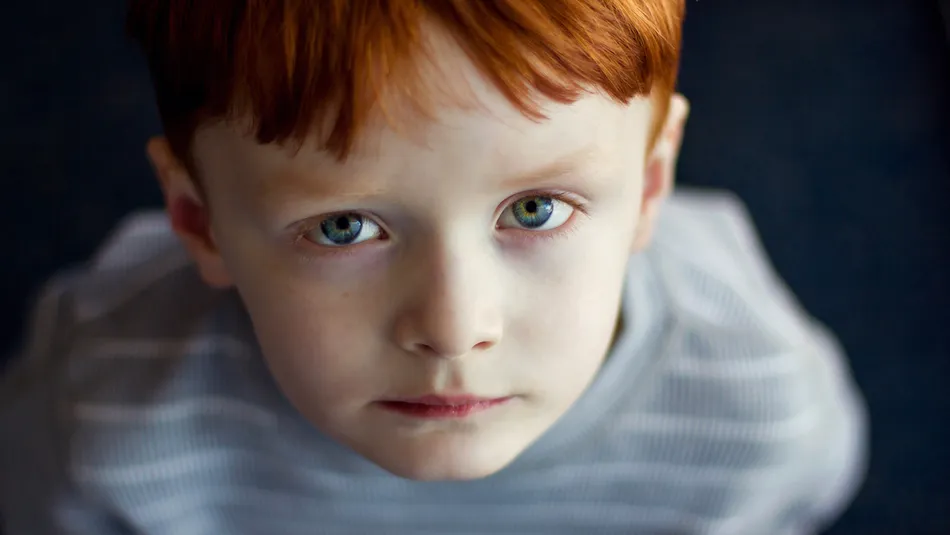 boy staring up at camera