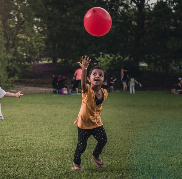 children playing with red balloon