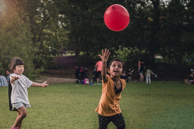 children playing with red balloon