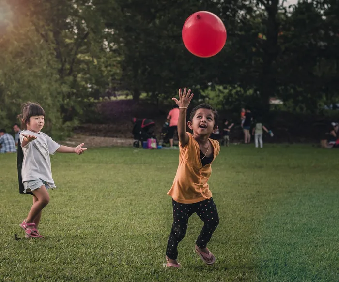 children playing with red balloon