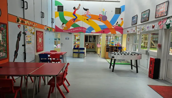 Creative hall with art work stuck up on the wall and table football