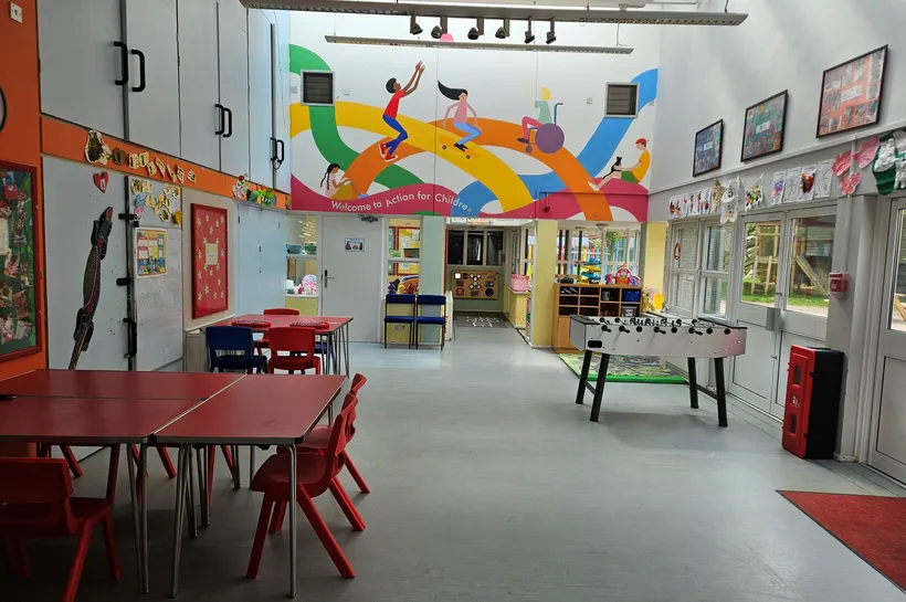 Creative hall with art work stuck up on the wall and table football