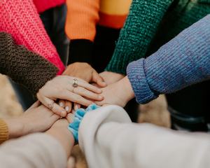 girl friends hands piled togethger