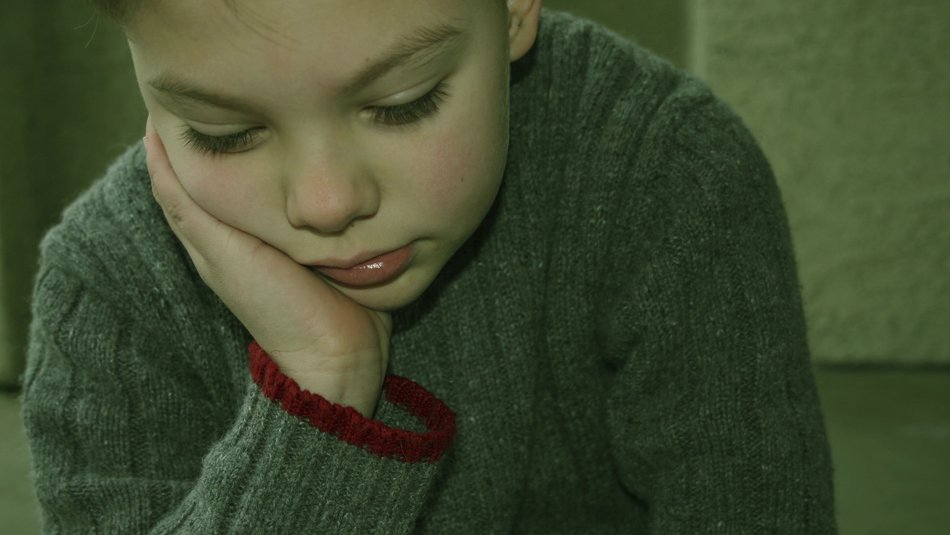 Boy in a sweater looking down