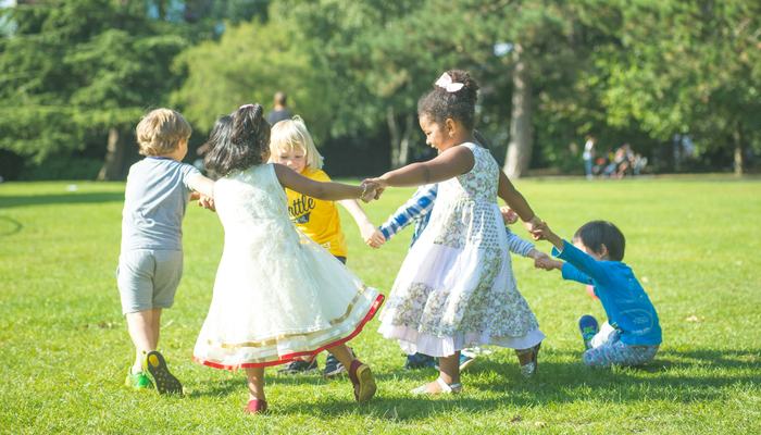 Children holding hands and walking around in a circle