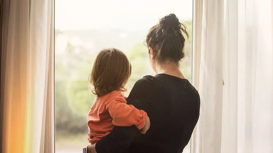 mother_holding_child_looking_out_