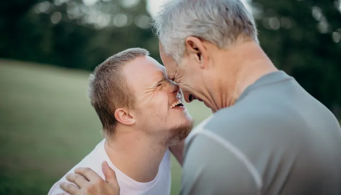 Teenager and dad laugh at each other