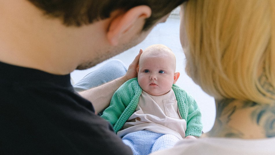 Baby in the arms of its parents