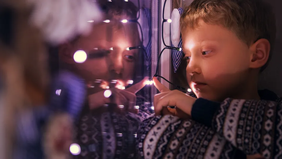 Boy looking out of the window at Christmas.jpg