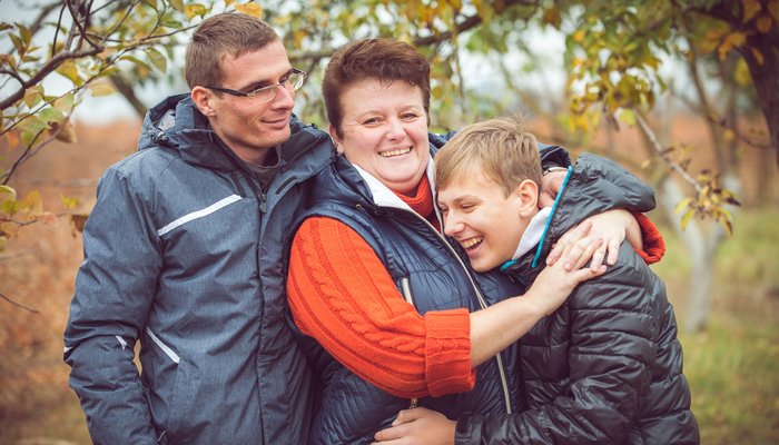Smiling family enjoying a walk on an autumn day