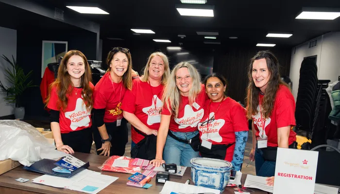 Volunteers standing at a desk with raffle tickets