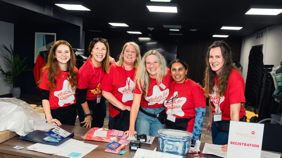 Volunteers standing at a desk with raffle tickets