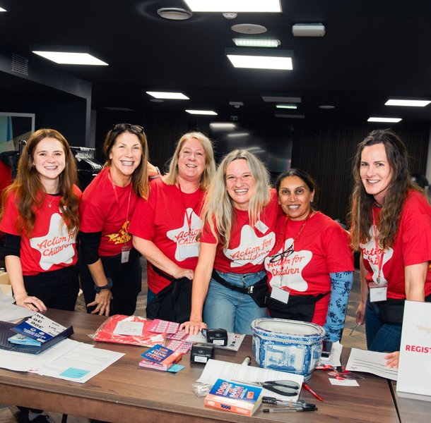 Volunteers standing at a desk with raffle tickets