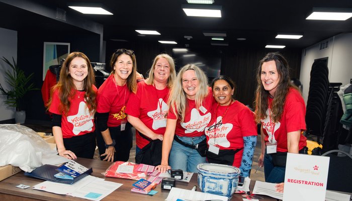 Volunteers standing at a desk with raffle tickets
