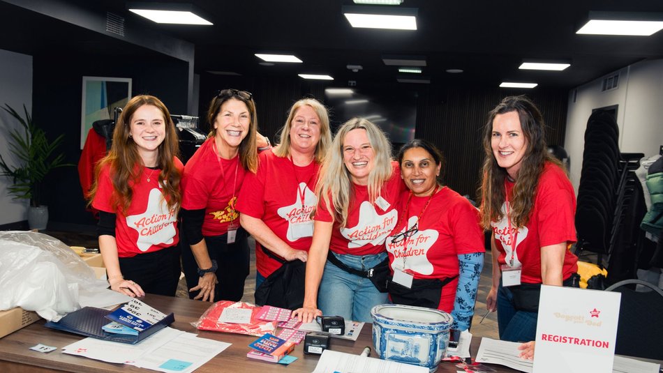Volunteers standing at a desk with raffle tickets